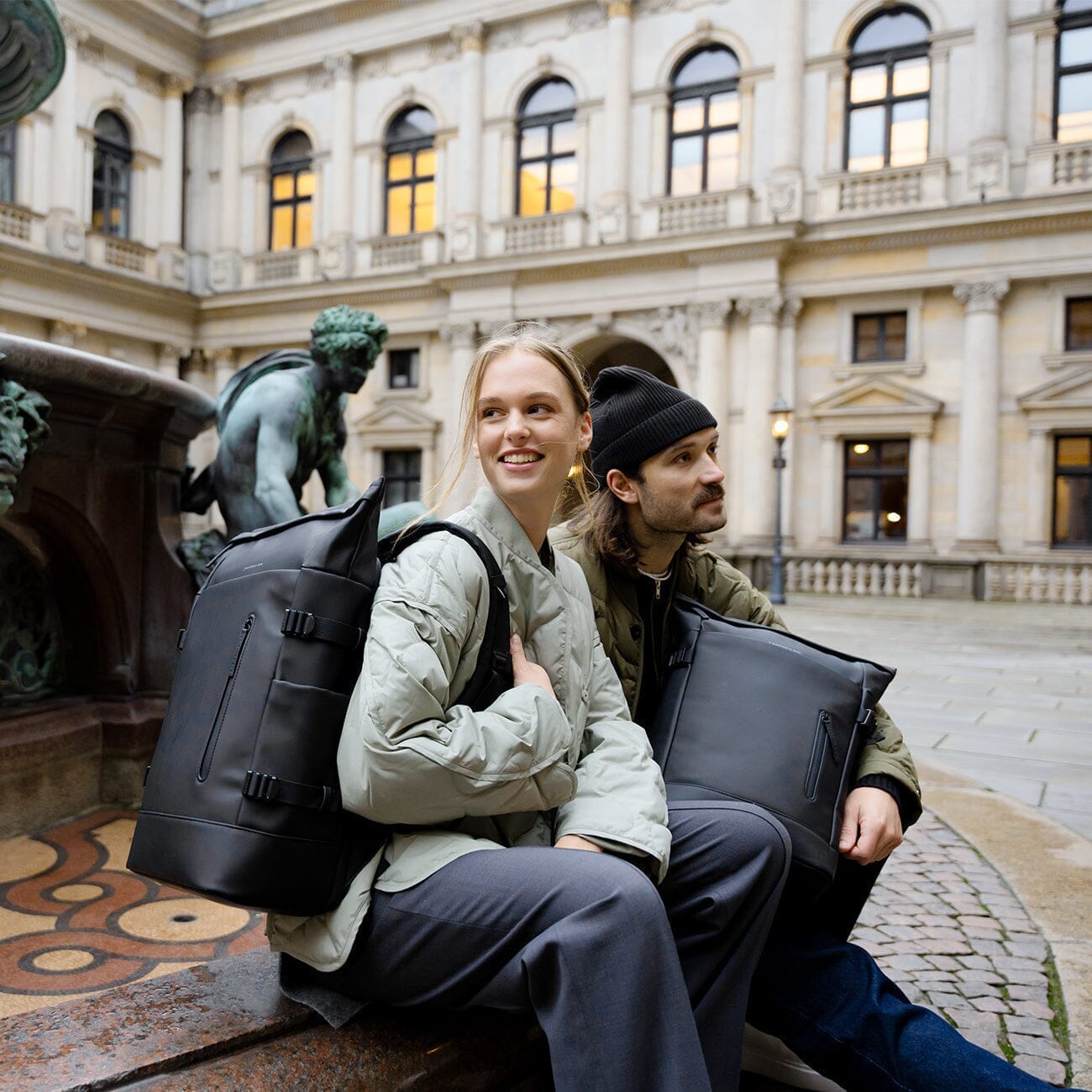 couple wearing kapten & son bags during city trip