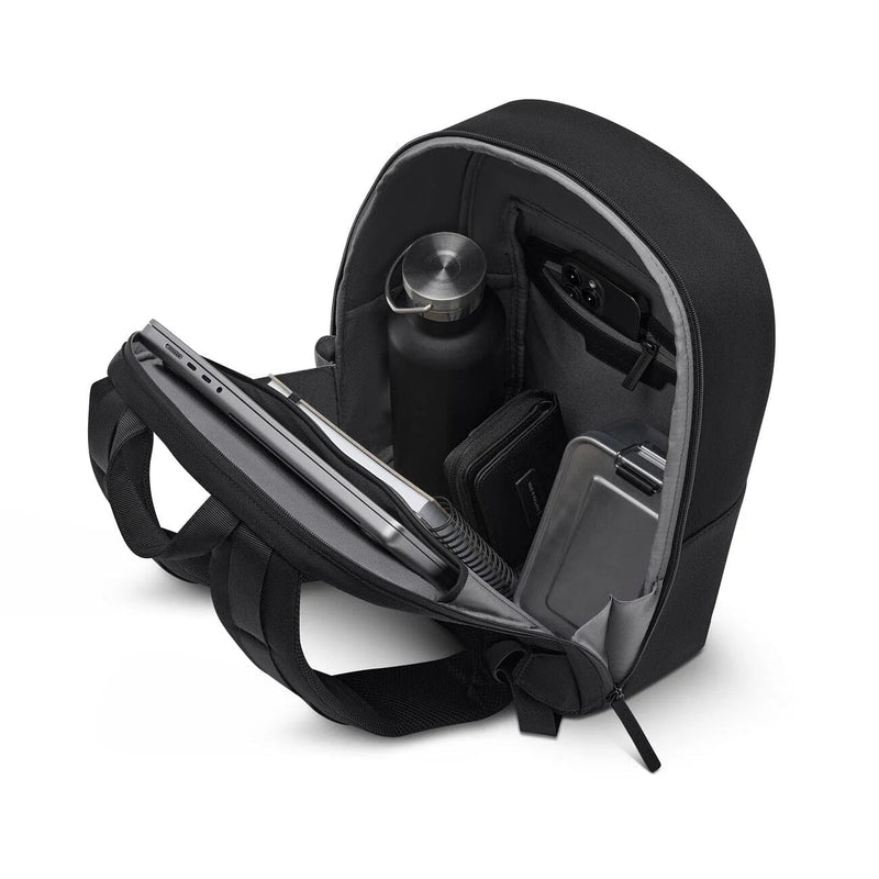 Back panel folded open and packed: laptop and notebook in the sleeve, water bottle, phone in the zip pocket
