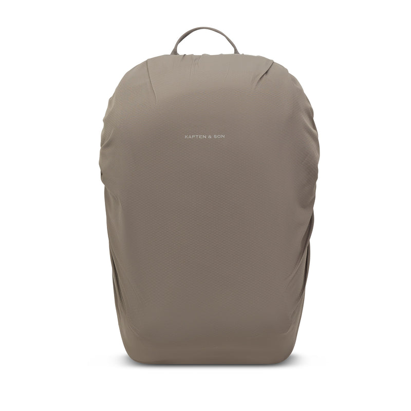 Taupe pack wearing its included rain cover