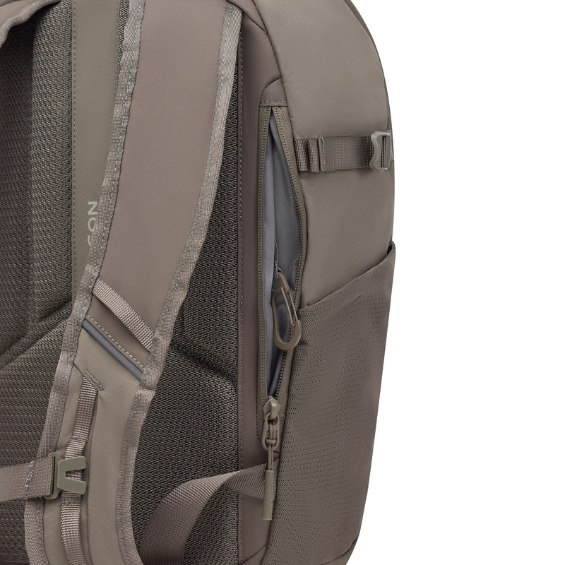 Anti-theft pocket open on the taupe pack, with its vertical zip along the back panel