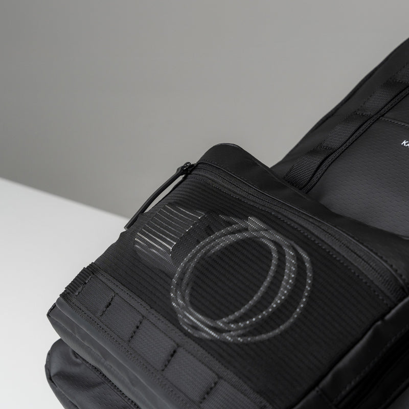 Charging cable stored in the front mesh pocket of the Bergen Ultra