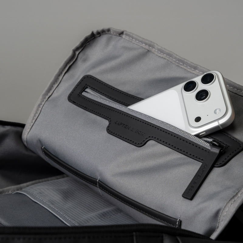 Phone in the inner mesh zip pocket of the Bergen Ultra backpack