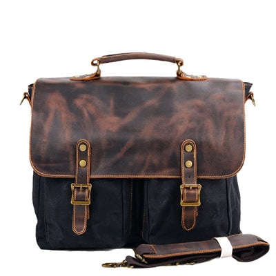 black vintage waxed canvas and full grain crazy horse leather messenger bag front white background