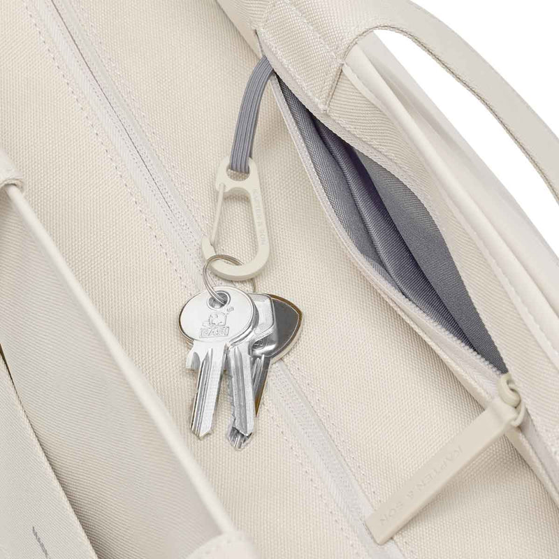 Keys on the carabiner on a grey cord inside the sandstone Hellvi Pro Large, next to the zipped inside pocket