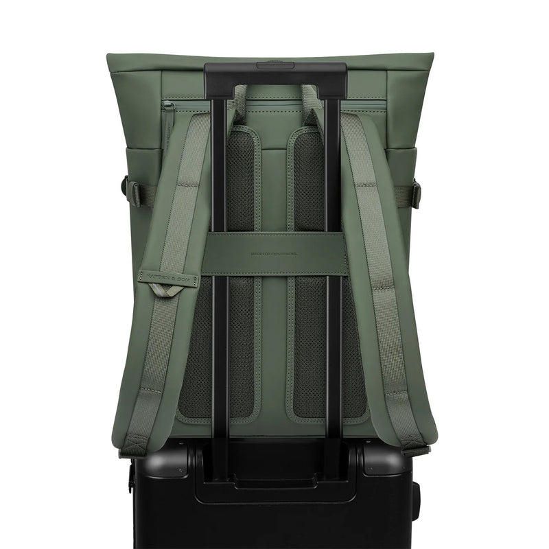 Luggage strap of the dusty green Helsinki over a suitcase handle