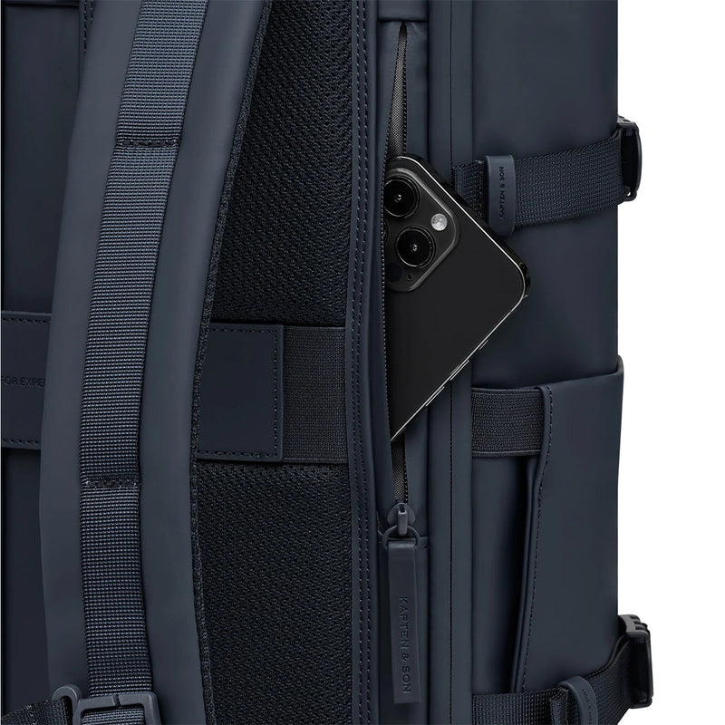 Phone in the anti-theft pocket on the back panel of the navy Helsinki Pro