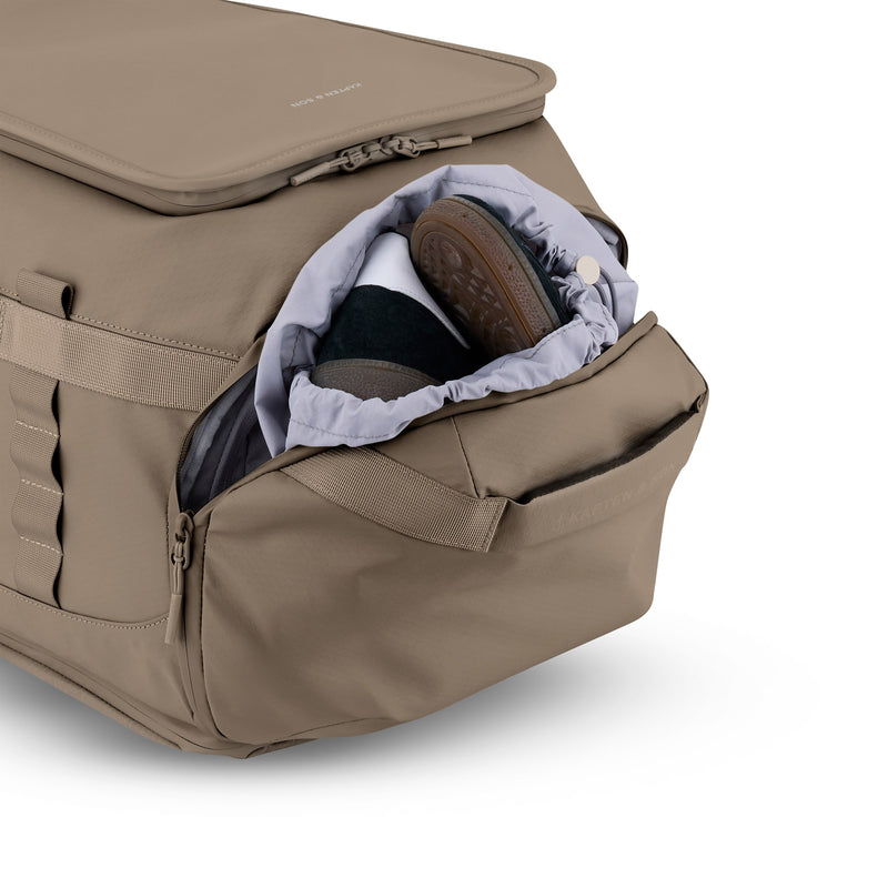 Shoes in the separate bottom pocket of the walnut Lisbon Duffle Backpack Medium