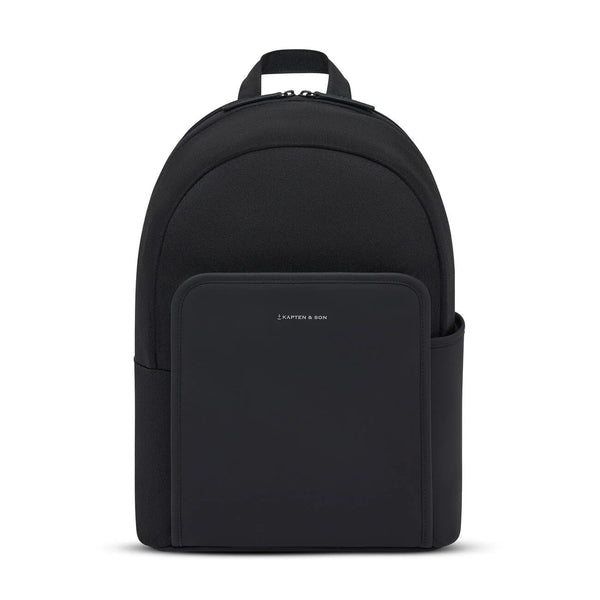 Kapten & Son Aalborg Backpack in black, rounded daypack with front zip pocket and silver logo