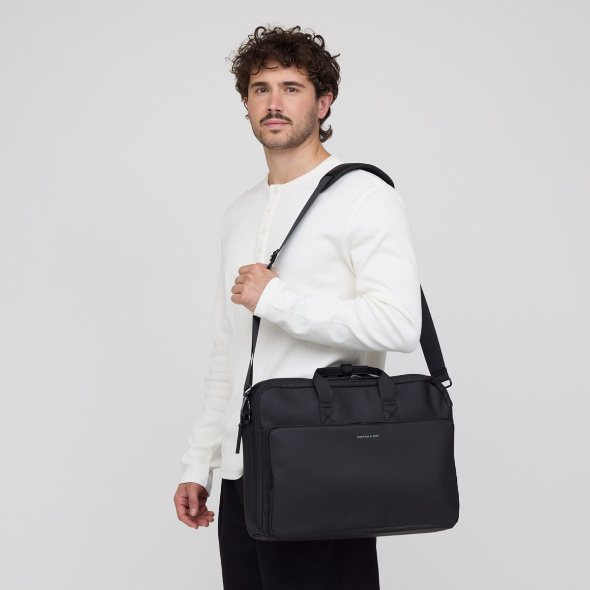 Man carrying the Bodo Laptop Bag on its shoulder strap