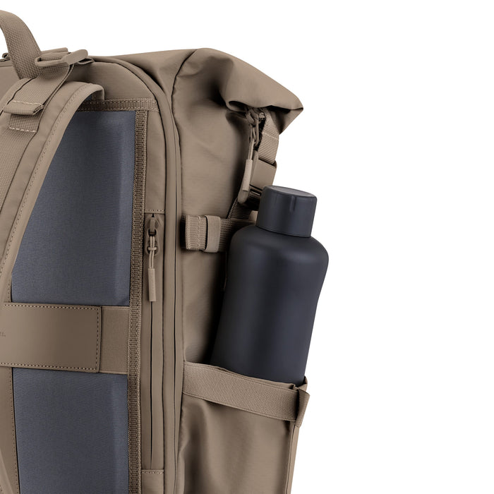 Side elastic bottle pocket close-up with water bottle — walnut