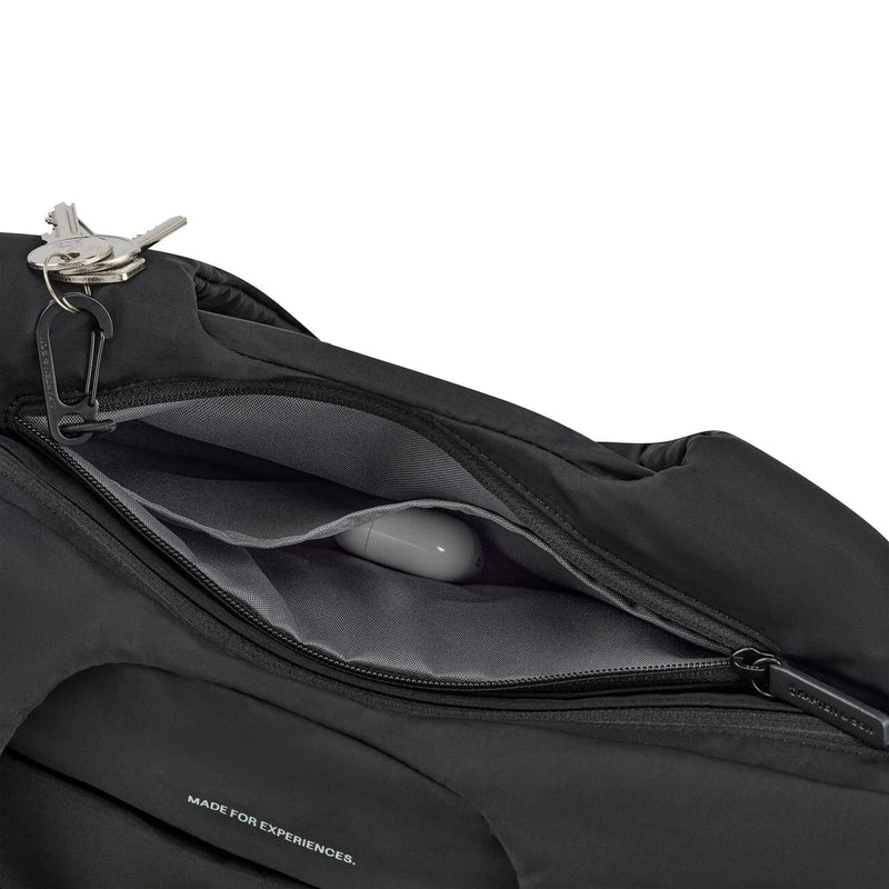 Zip pocket holding earbuds, with keys on the key clip