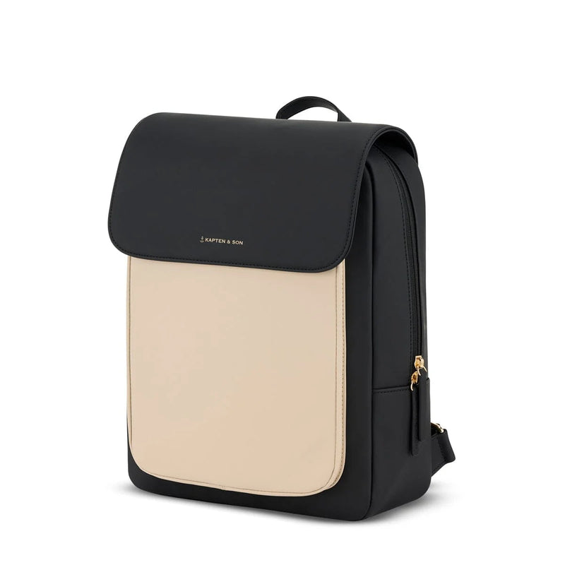 Three-quarter view of the cream black Tromso showing the contrast front panel and gold side zip