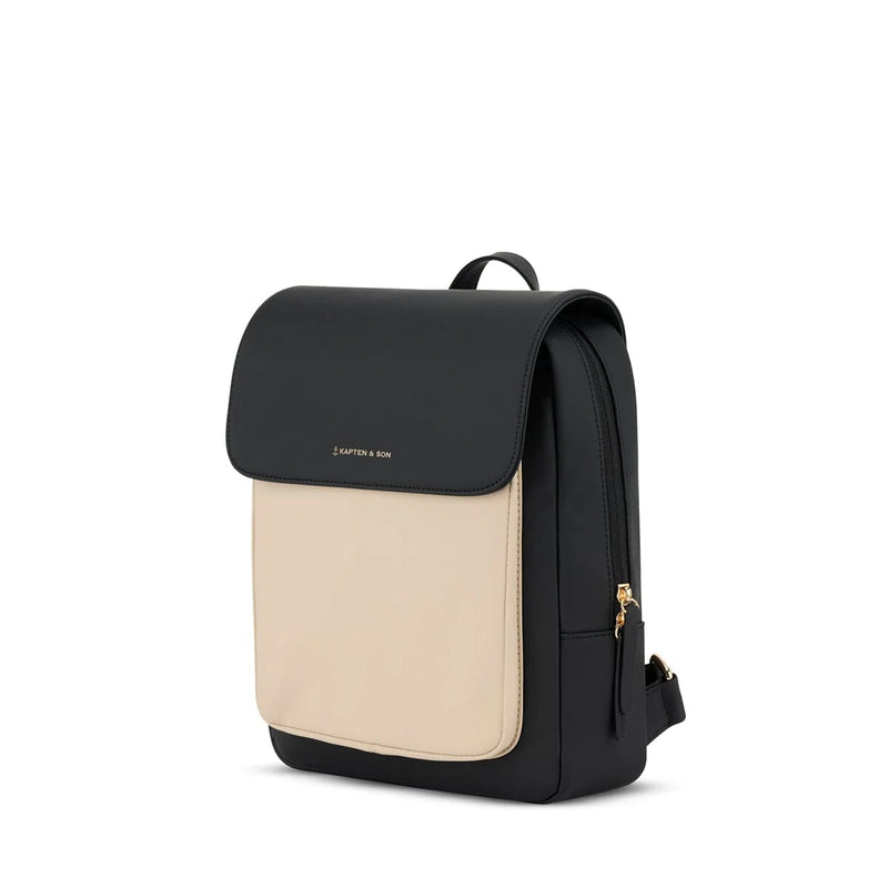 Three-quarter view showing the cream front panel contrast and gold side zip