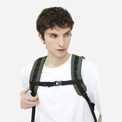 man wearing green sustainable travel backpack sternum belt close up
