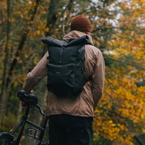 cyclist in a forest wearing the ruben 2.0 backpack