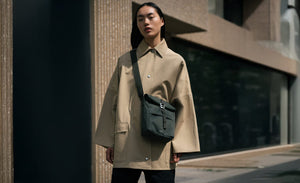 woman wearing a black icon sacoche shoulder bag by Sandqvist