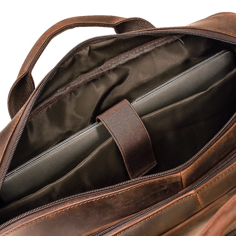 padded leather shoulder strap of the travel messenger bag
