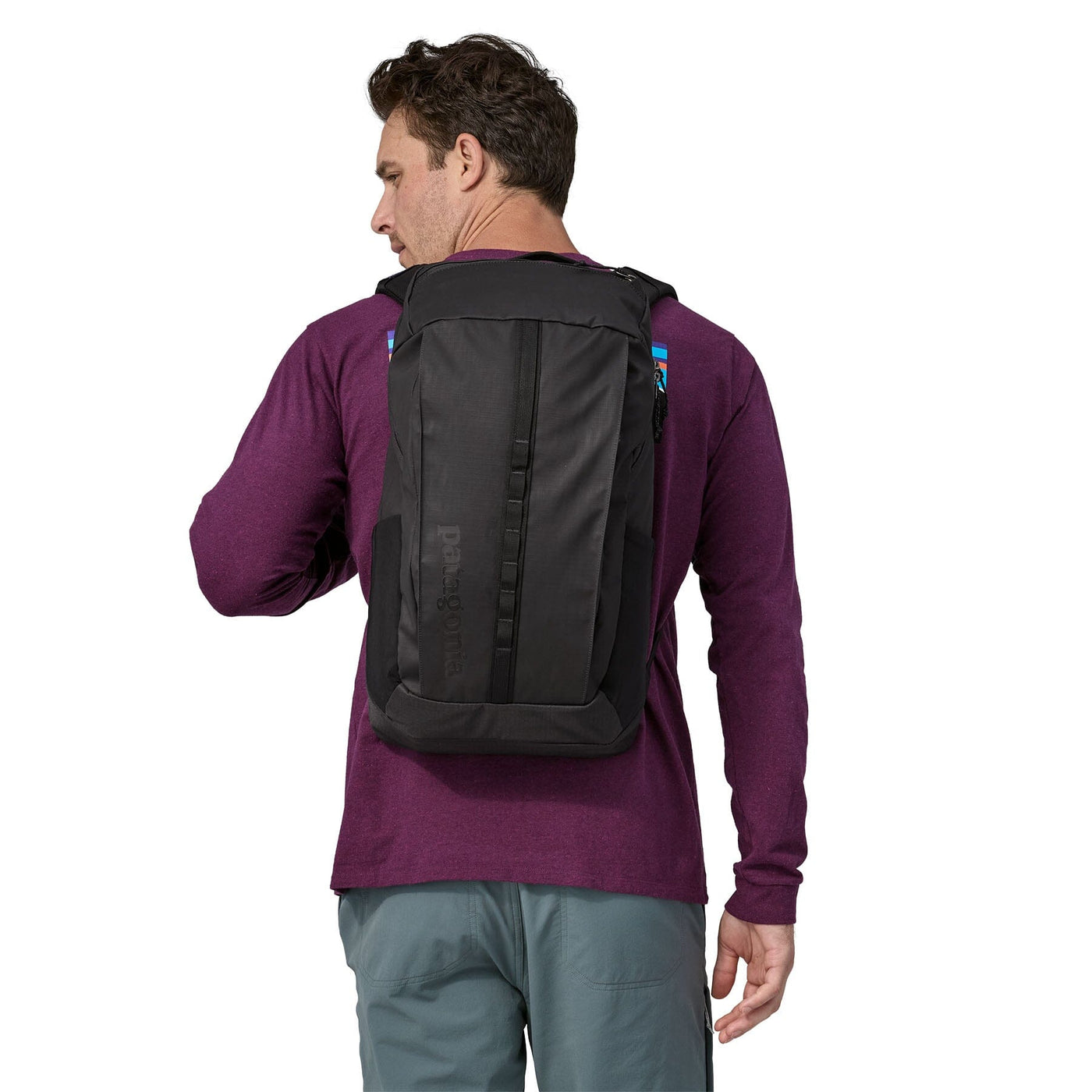 man model wearing the Black Hole Pack 25L in black, back view