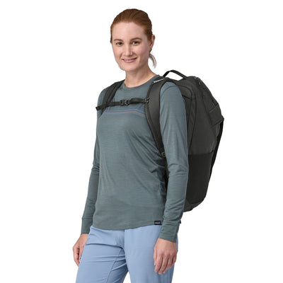 woman model wearing the Black Hole Pack 32L in black, front view