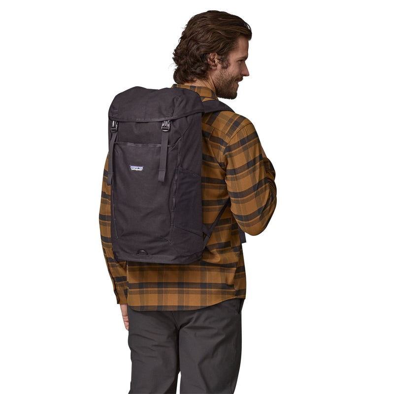 man model wearing the Fieldsmith Lid Pack 28L in black, back view