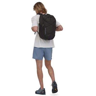 man model wearing the Refugio Daypack 30L in black, back view 2