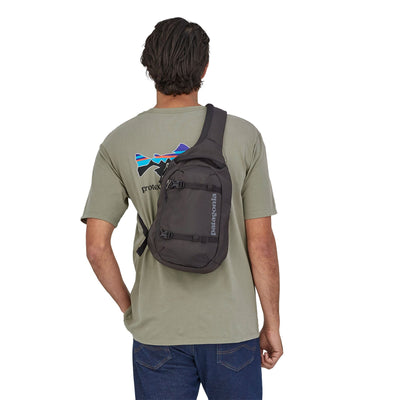 man model wearing the Atom Sling 8L in black, back view