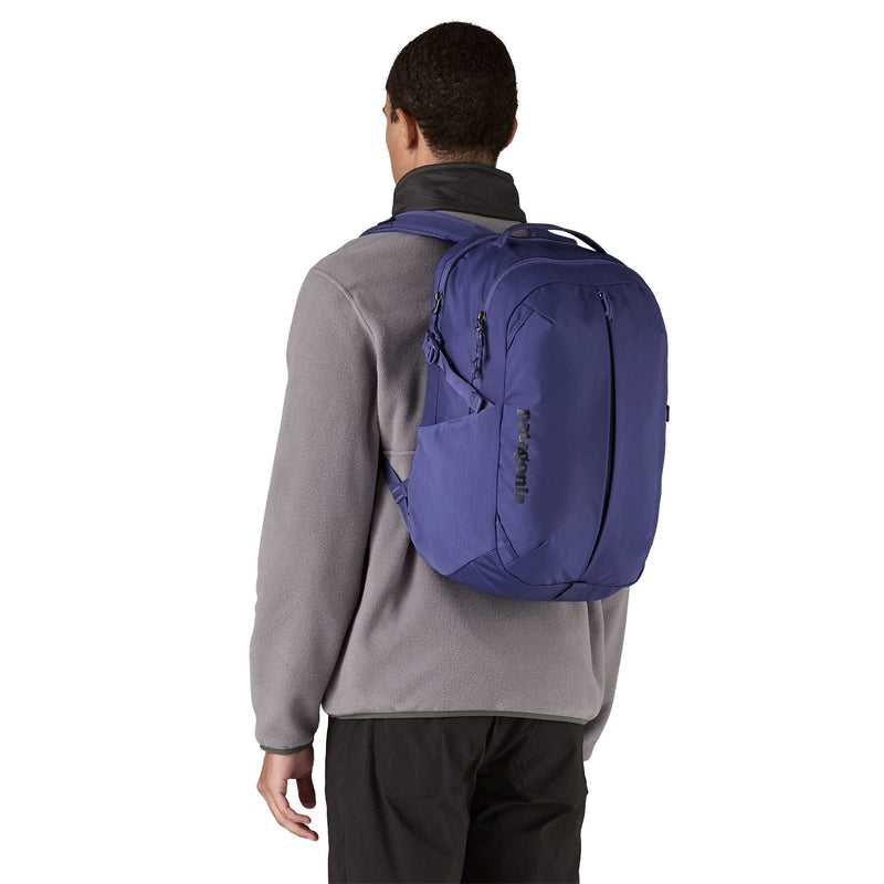 man model wearing the Refugio Daypack 26L in solstice purple, back view