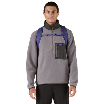 man model wearing the Refugio Daypack 26L in solstice purple, front view