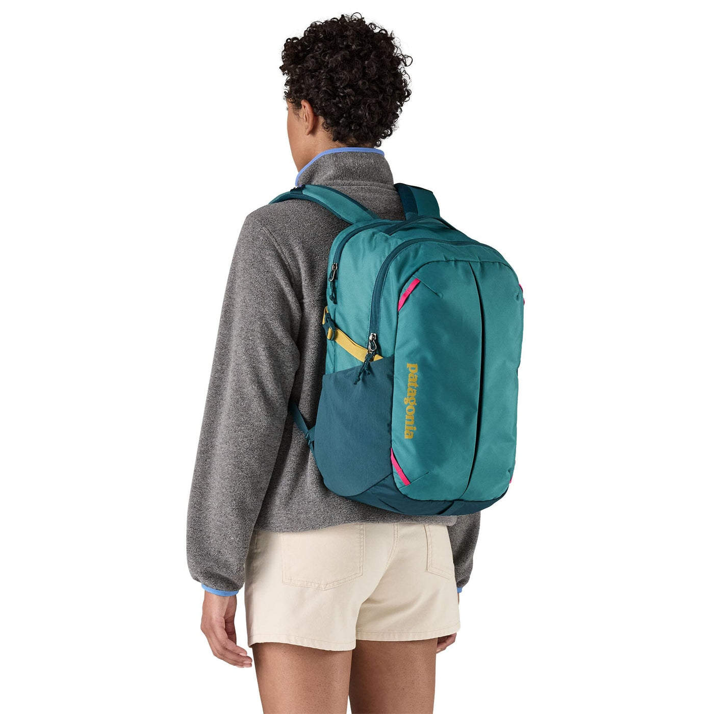 woman model wearing the Refugio Daypack 26L in wetland blue, back view