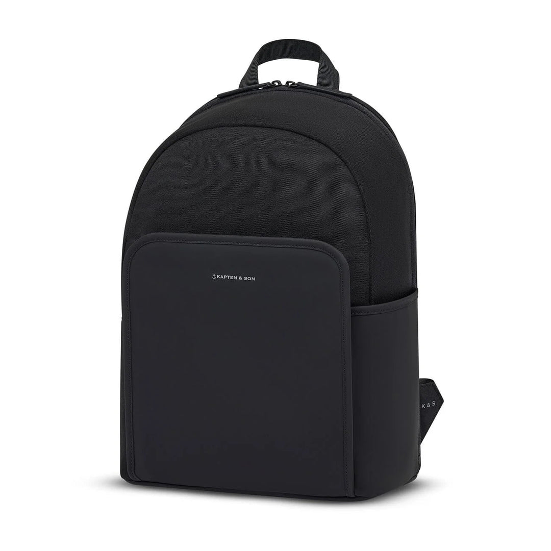 Three-quarter view of the Aalborg backpack showing the rounded silhouette, front pocket and side water bottle slot