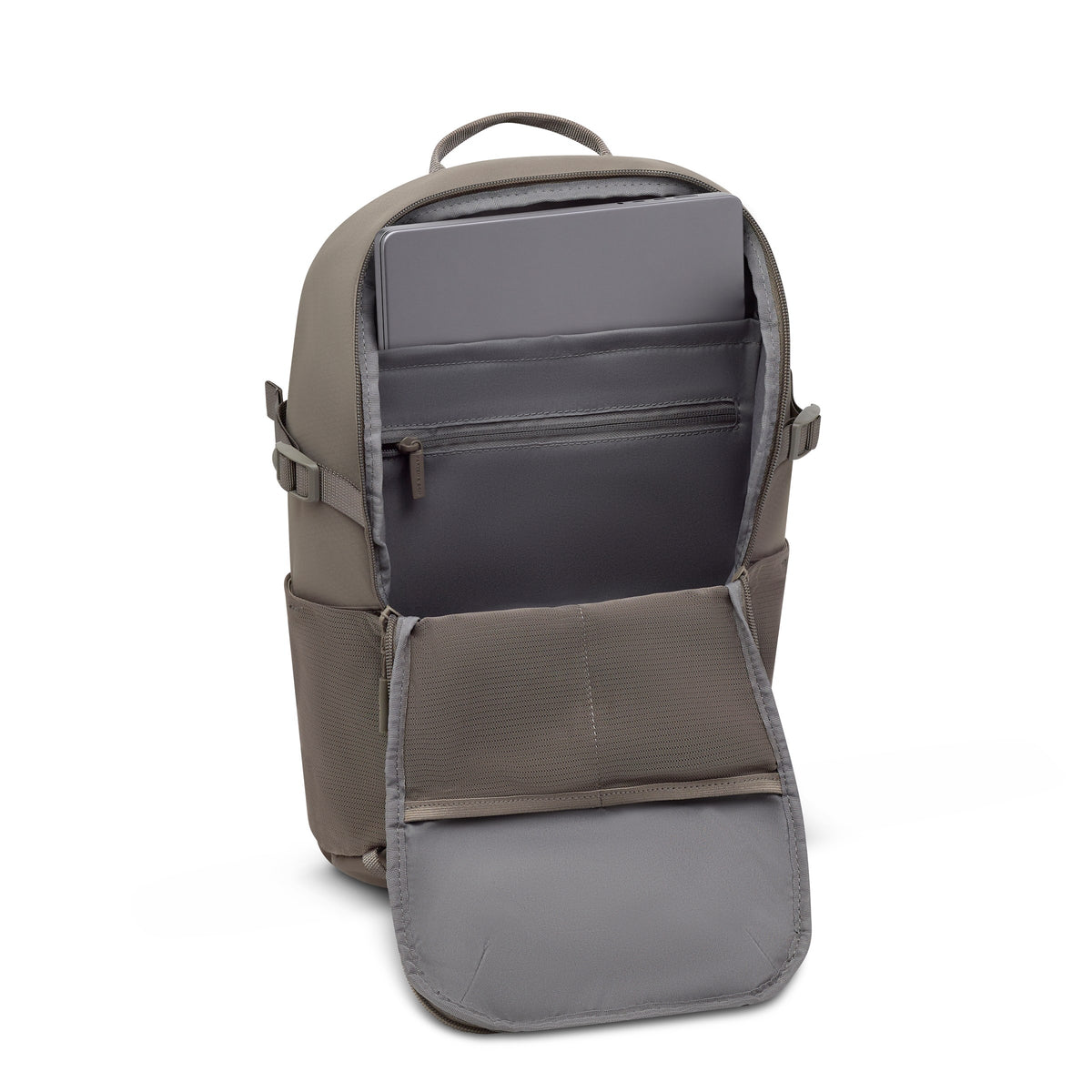 Laptop resting in the laptop compartment of the taupe backpack with the front panel folded open