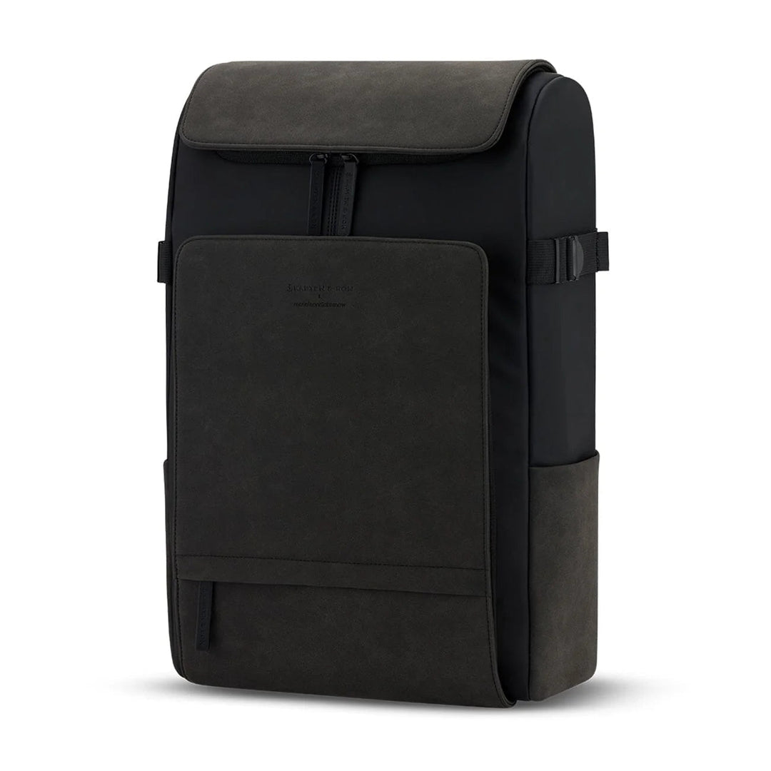 Three-quarter view showing the boxy silhouette, side compression straps and water bottle pocket