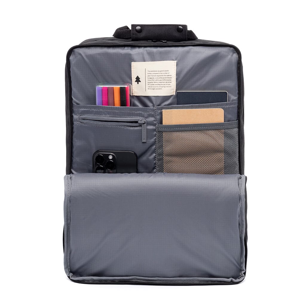 Interior view of sustainable black backpack displaying compartments, laptop sleeve and pockets