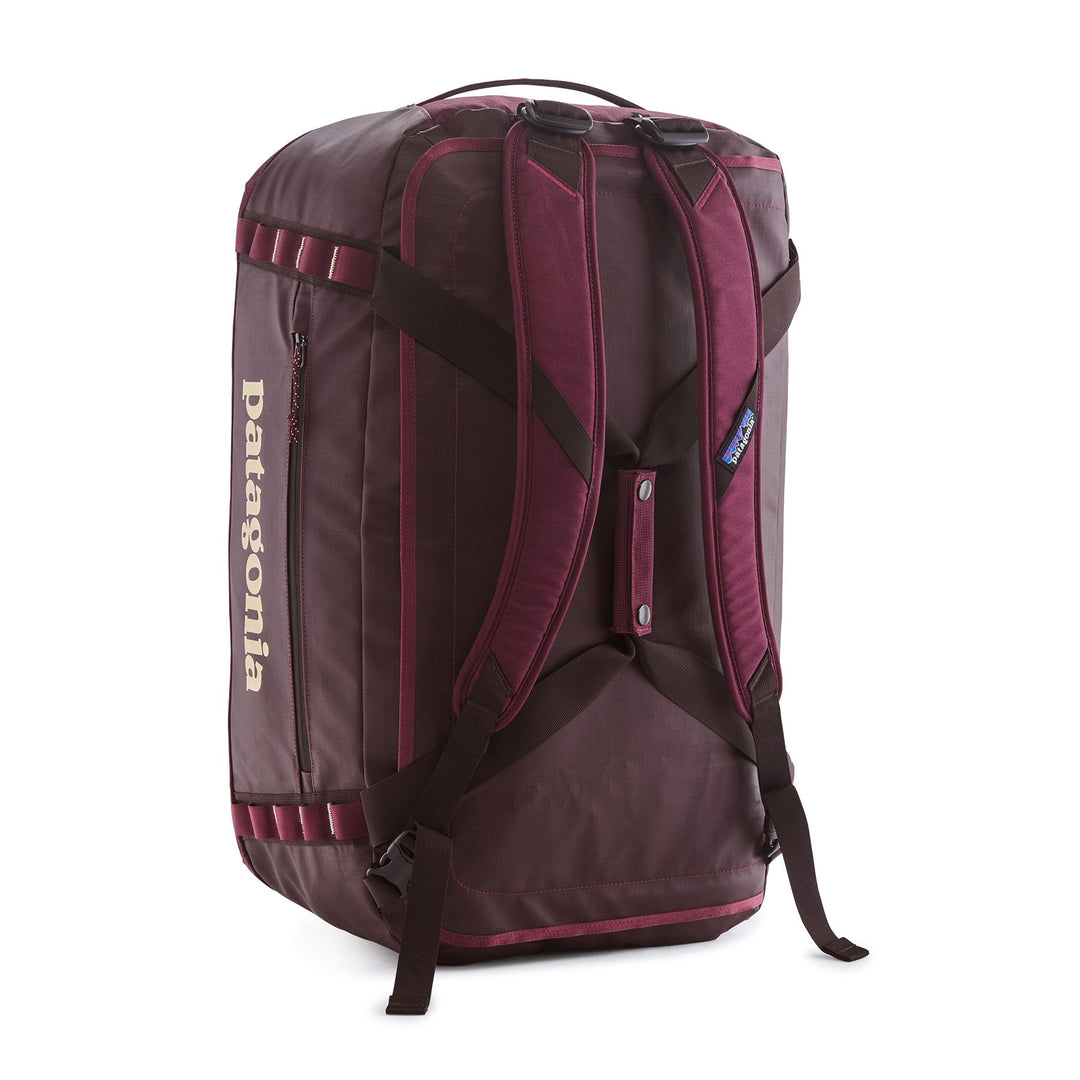 Black Hole Duffel 55L in Berry Fig — back panel with padded removable backpack straps
