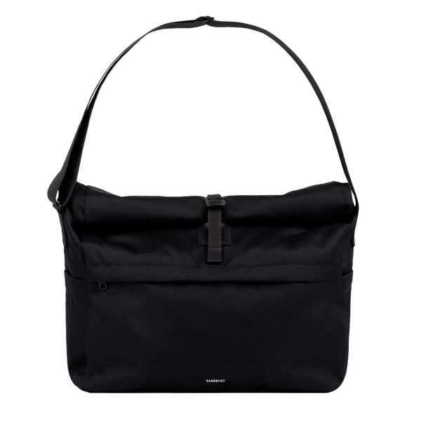 Sleek black messenger bag worn crossbody, ideal for commuting with a laptop and everyday essentials