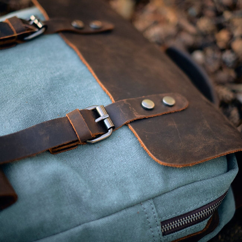 close up view on the magnetic buckles and leather cap of the helsinki backpack