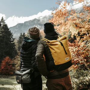 couple hiking forest yellow eco friendly roll top hiking backpack mero mero