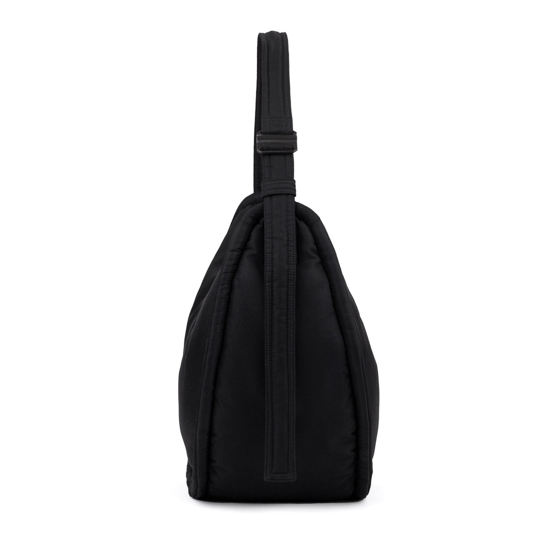 Black Curve half-moon bag standing upright with the strap gathered