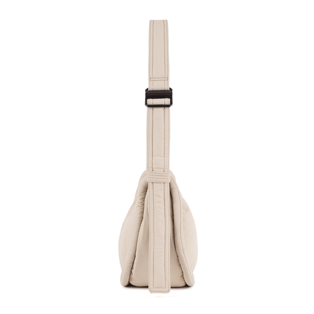 Beige Curve Mini half-moon bag standing upright, front view of the 3L body