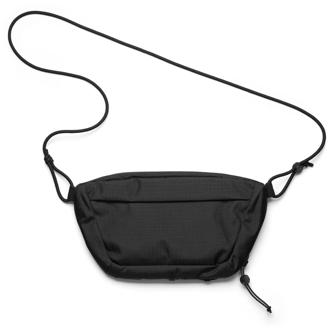 DB Journey Roamer Pro Sling Bag 6L in black — front view with bungee cord