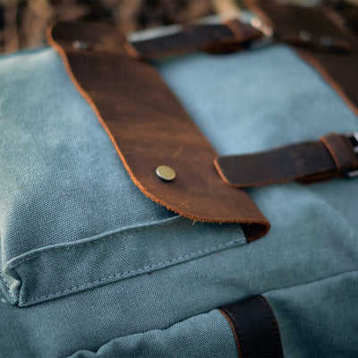 canvas and leather backpack helsinki close up, front clipped pocket with leather cap