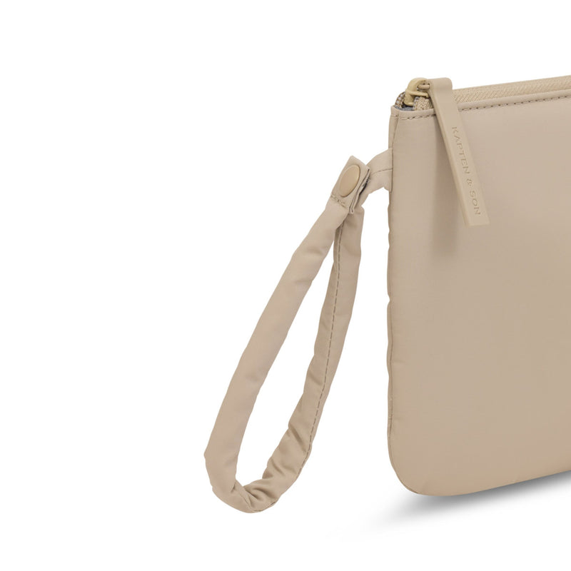 Close-up of the wrist strap and press stud on the sandstone pouch