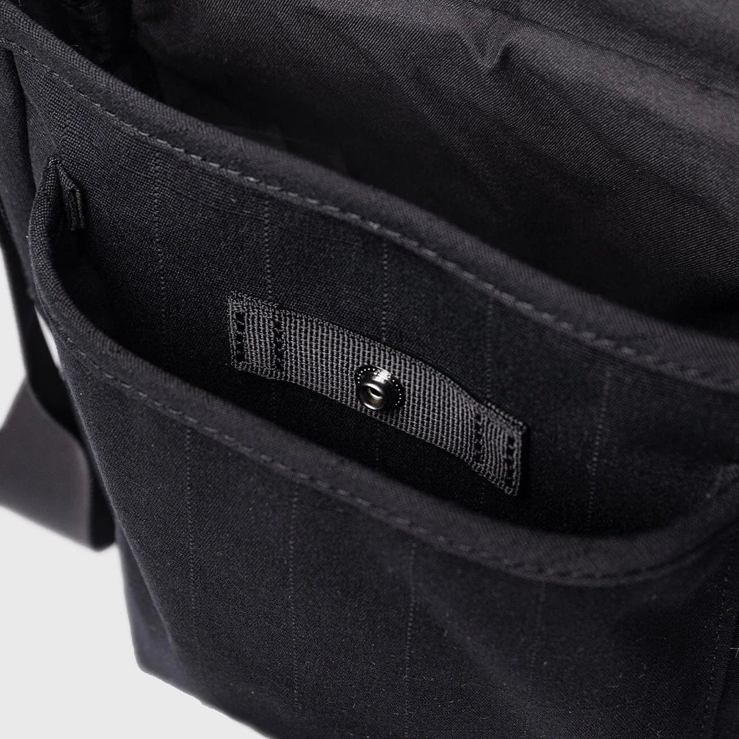 Sandqvist Everyday Crossbody Bag in black, interior pockets and organizer detail