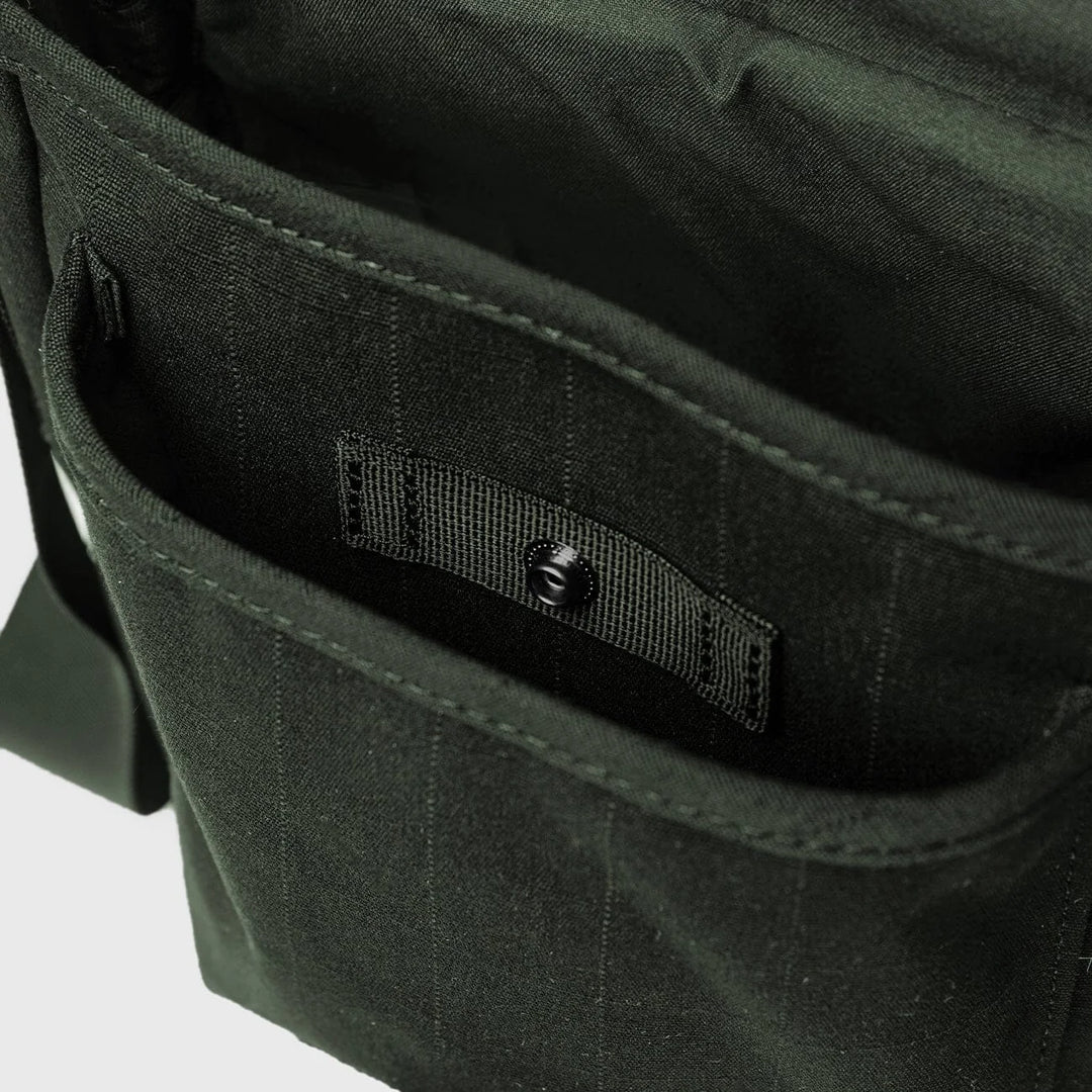 Sandqvist Everyday Crossbody Bag in dark green, interior pockets and organizer detail