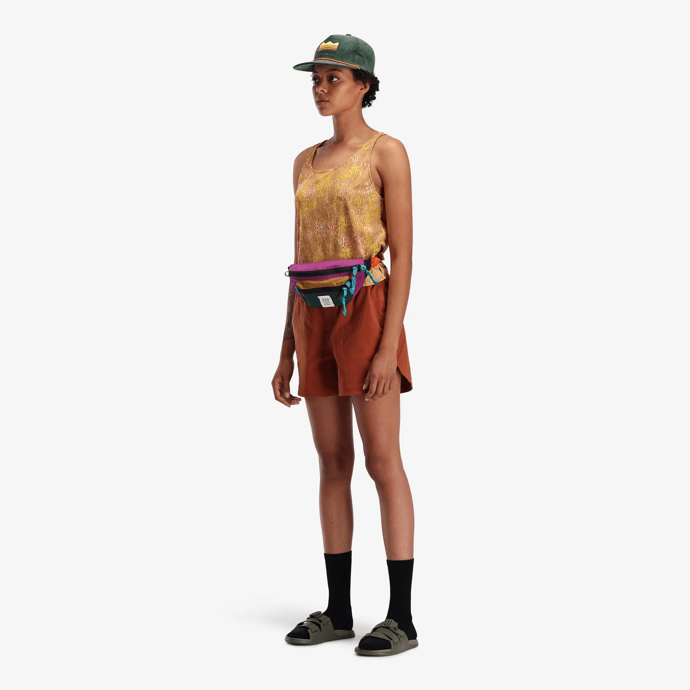 female hiker wearing topo designs mountain waist pack as bum bag