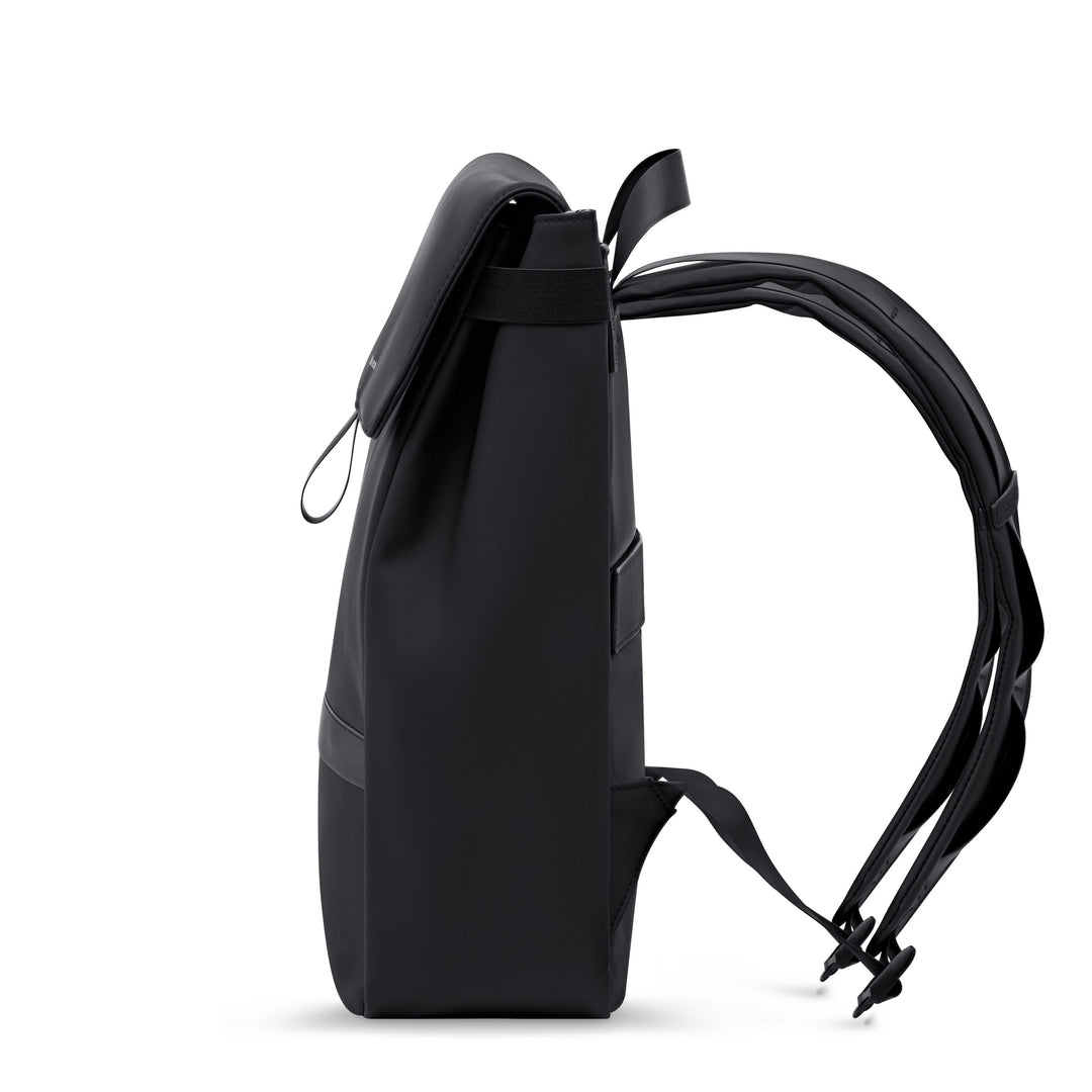 Fyn Sleek all black flap-top commuter backpack with webbing strap, side profile showing clean silhouette