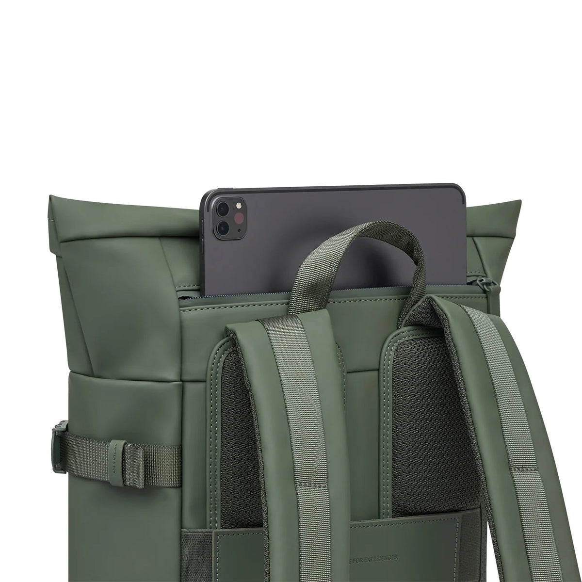 Tablet slid into the quick-access pocket on the back of the dusty green Helsinki
