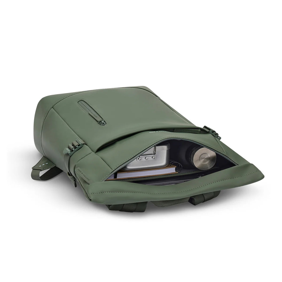 Dusty green Helsinki opened, with a metal lunch box, a spiral notebook and an insulated bottle inside