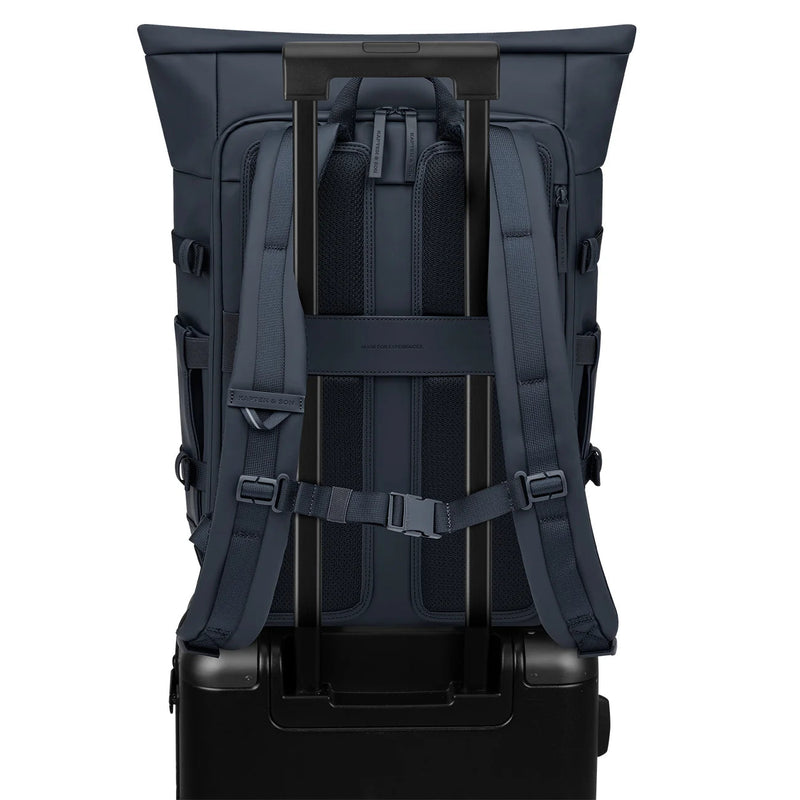 Luggage strap of the navy Helsinki Pro over a suitcase handle