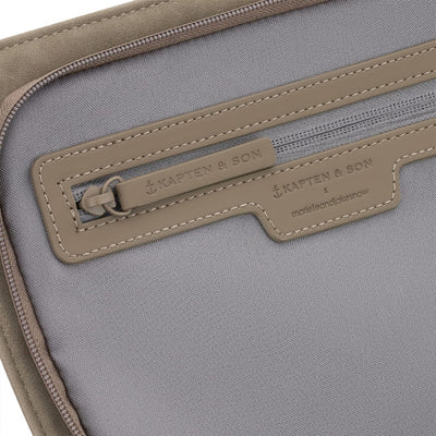 Detailed view of the interior zip pocket with Kapten & Son branding, emphasizing craftsmanship and functional finishing